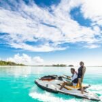 Two people riding a Jet ski in clear blue waters in Dubai