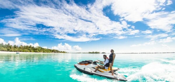 Two people riding a Jet ski in clear blue waters in Dubai