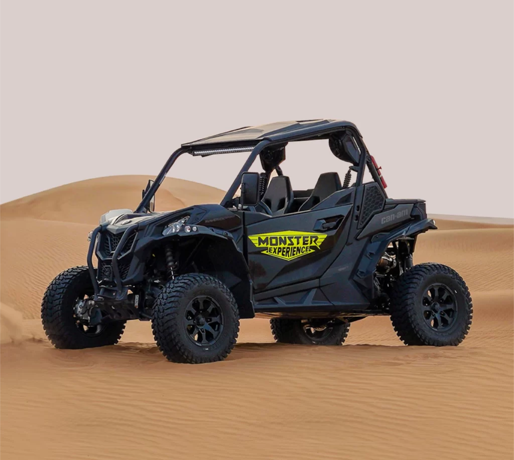 black color 2 seater buggy sitting on sand dune. can am maverick sport 2 seater buggy in desert