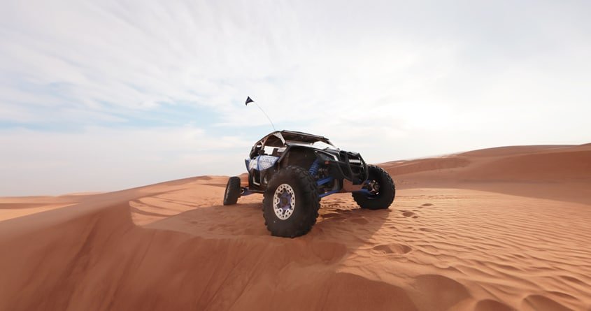 blue desert buggy in the desert dune can-am x3 2 seater